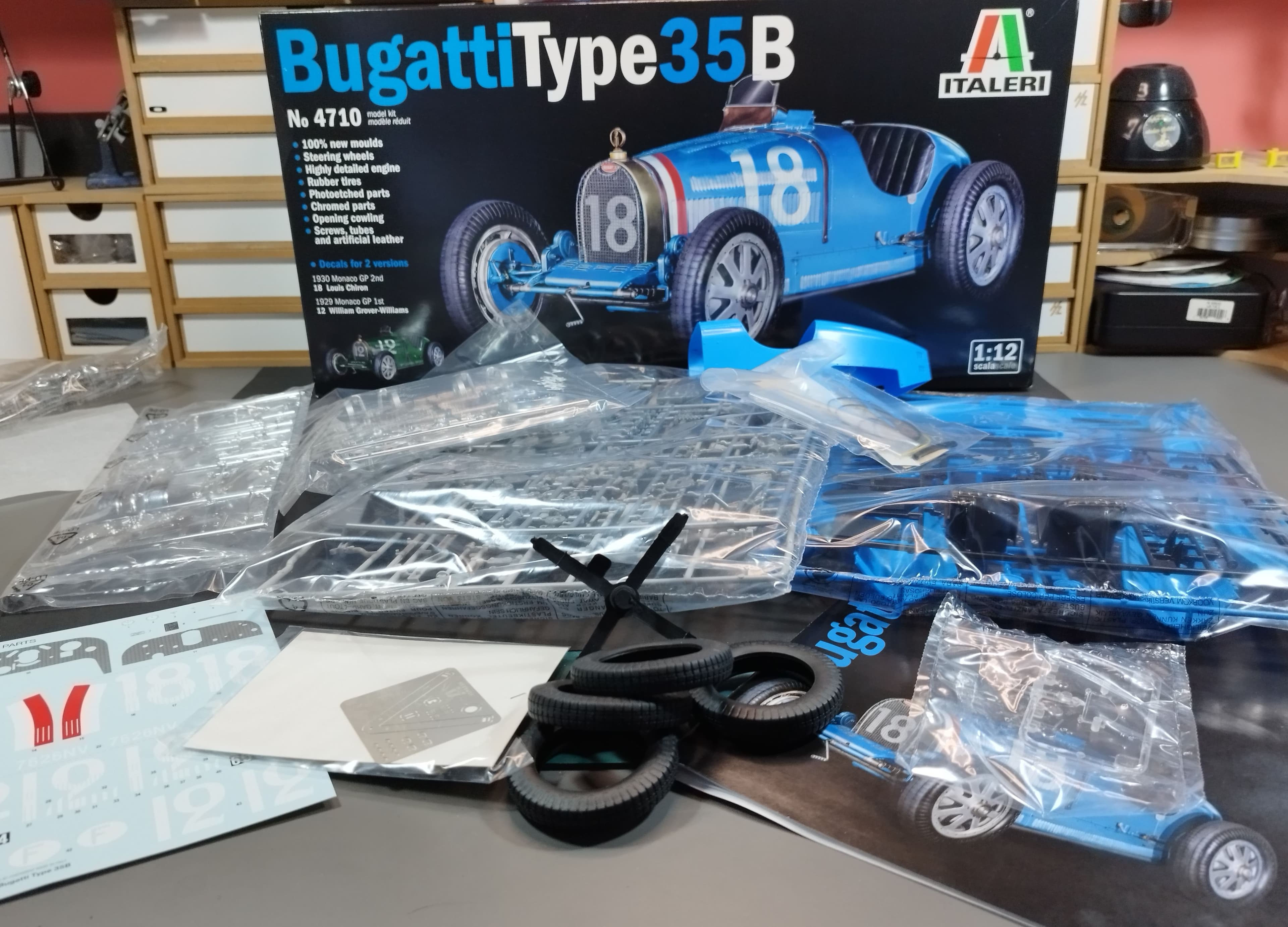 The journey begins with the kit in its original state. The large Italeri box sits in the background, showing the finished "French Racing Blue"